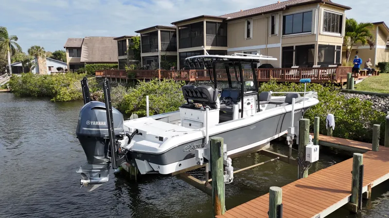 Slide: The Image of 2020 Crevalle 26 HCO Yamaha 300 boat docked near waterfront homes. - 4