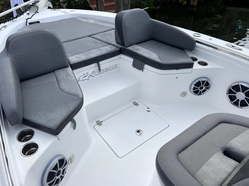 Slide: The Image of 2020 Crevalle 26 HCO Yamaha 300 boat interior with gray seating and storage compartments. - 40
