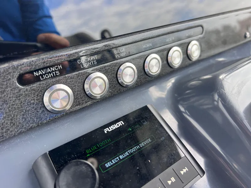 Slide: The Image of Close-up of 2020 Crevalle 26 HCO Yamaha 300 boat control panel and Fusion Bluetooth device. - 47