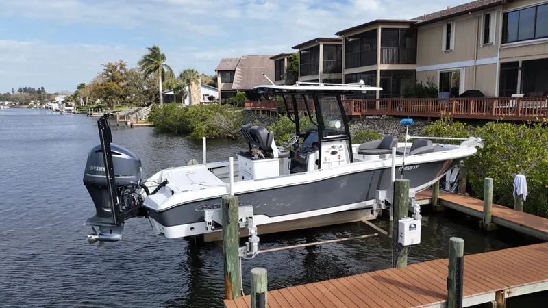Slide: The Image of 2020 Crevalle 26 HCO Yamaha 300 boat docked by waterfront homes. - 5