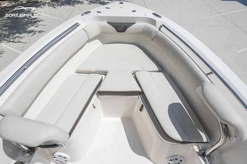 Slide: The Image of 2023 Sailfish 220 CC boat interior with cushioned seating and stainless steel rails. - 11