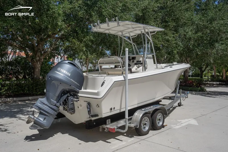 Slide: The Image of 2023 Sailfish 220 CC boat on trailer with Yamaha outboard motor, parked outdoors. - 4