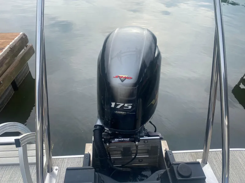 Slide: The Image of 2022 SunCatcher Select 322RC with 175 horsepower outboard motor on a calm lake. - 10