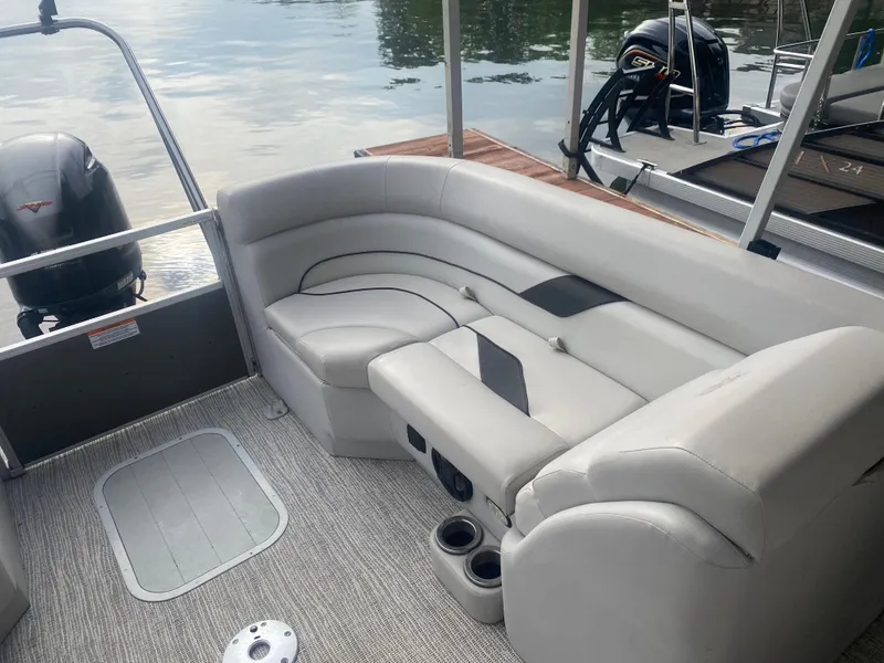 Slide: The Image of 2022 SunCatcher Select 322RC pontoon boat interior with plush seating and cup holders. - 13
