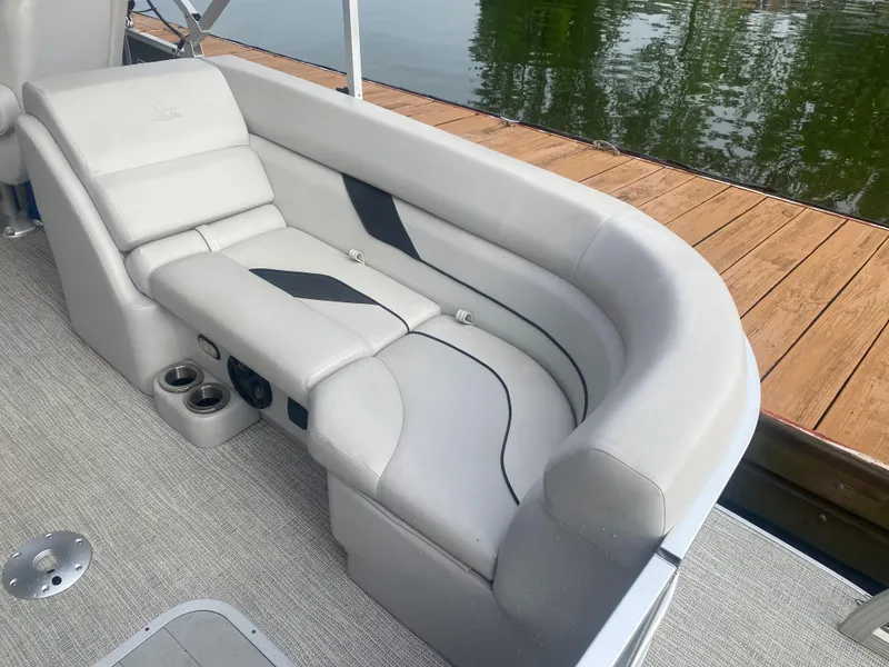 Slide: The Image of 2022 SunCatcher Select 322RC boat interior with plush seating and cup holders. - 14