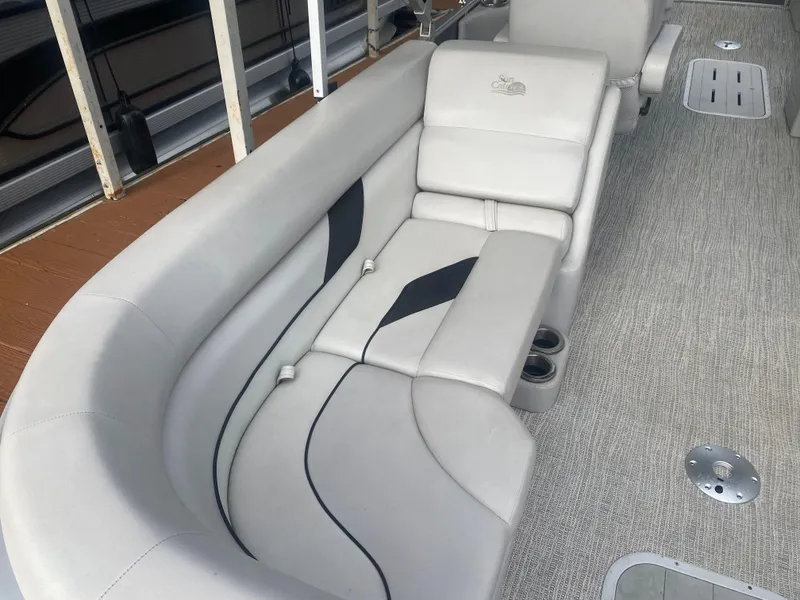 Slide: The Image of 2022 SunCatcher Select 322RC boat interior with plush seating and cup holders. - 15