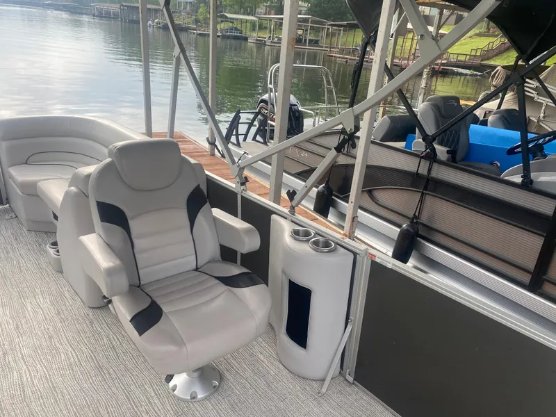 Slide: The Image of 2022 SunCatcher Select 322RC pontoon boat interior with comfortable seating and lake view. - 3