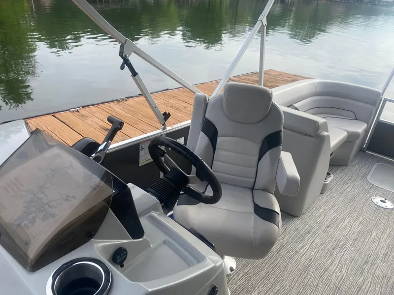 Slide: The Image of 2022 SunCatcher Select 322RC pontoon boat interior with captain's chair and steering console. - 5
