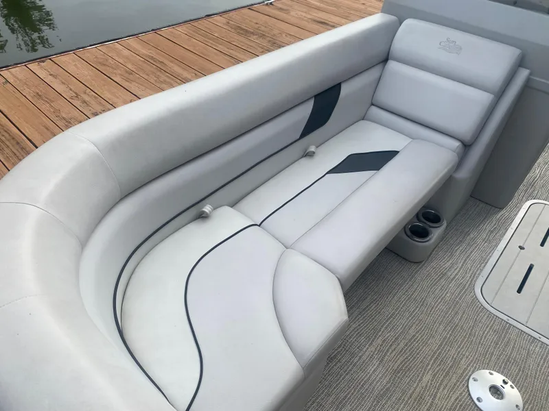 Slide: The Image of 2022 SunCatcher Select 322RC boat interior with plush seating and cup holders. - 6