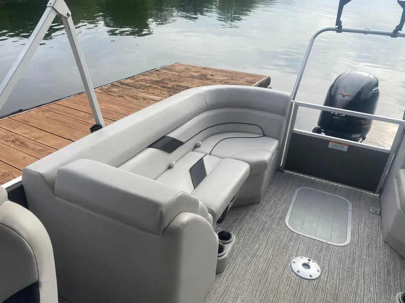 Slide: The Image of 2022 SunCatcher Select 322RC pontoon boat with gray seating, docked by a wooden pier. - 7