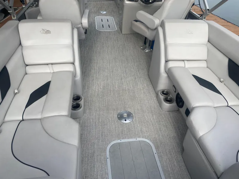 Slide: The Image of 2022 SunCatcher Select 322RC interior with plush seating and modern design. - 9