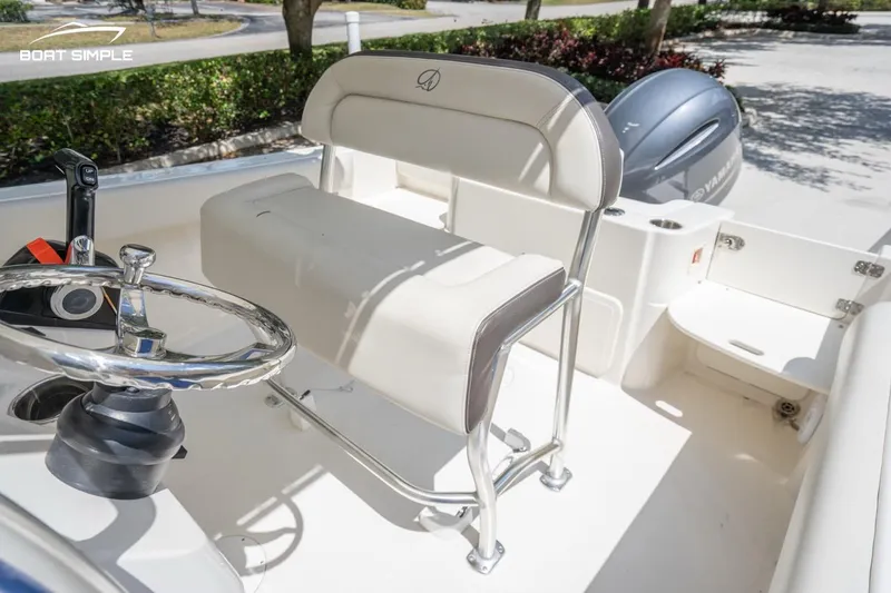 Slide: The Image of 2023 Sailfish 220 CC boat interior with steering wheel and seating. - 12