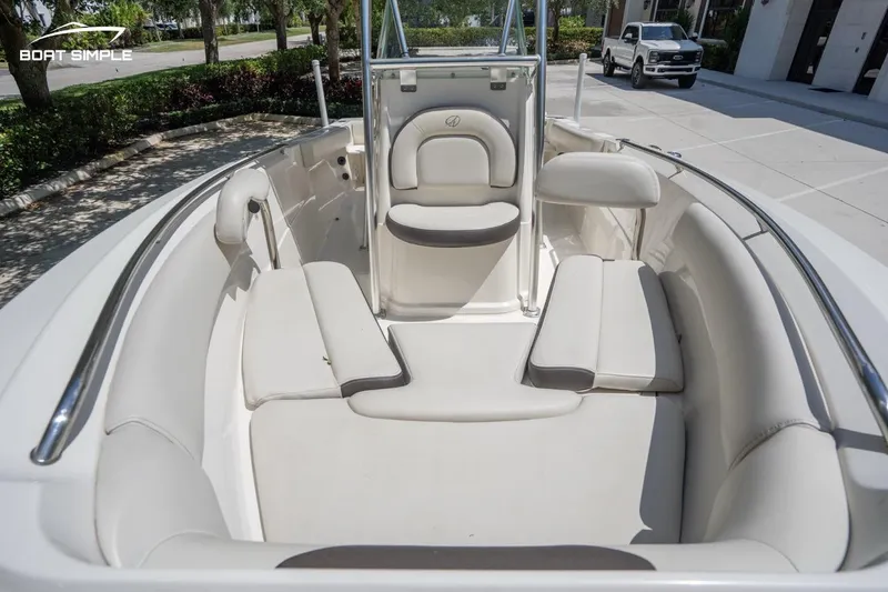 Slide: The Image of 2023 Sailfish 220 CC boat interior with cushioned seating and sleek design. - 13