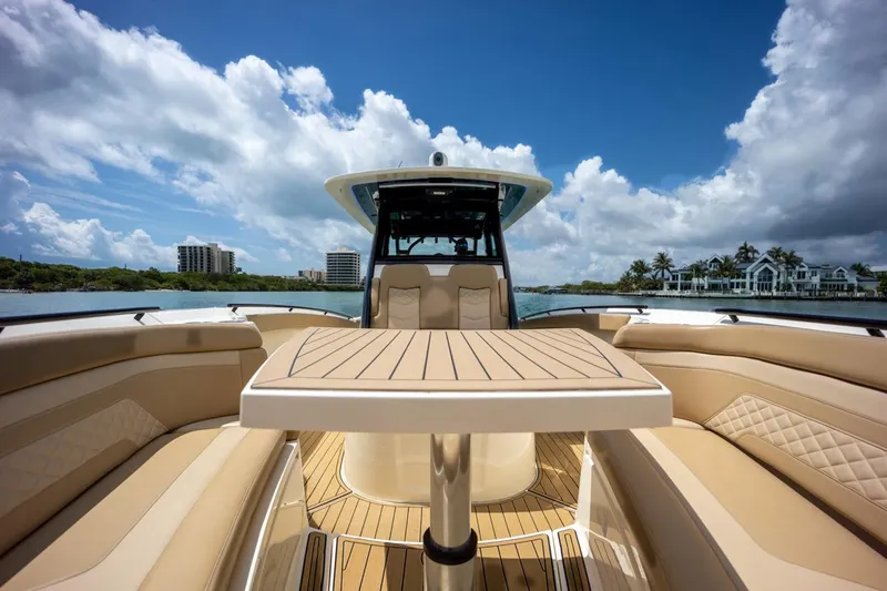 Slide: The Image of 2022 Scout 330 LXF boat interior with table and seating. - 10