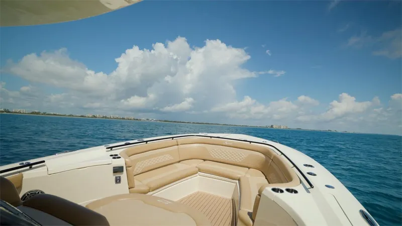 Slide: The Image of 2022 Scout 330 LXF boat on open water with clear skies. - 11