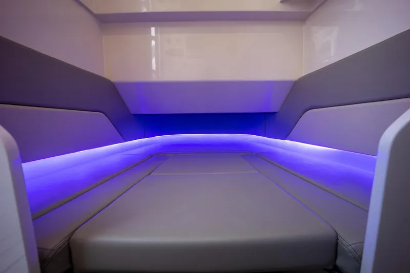 Slide: The Image of 2022 Scout 330 LXF boat interior with ambient blue LED lighting. - 15