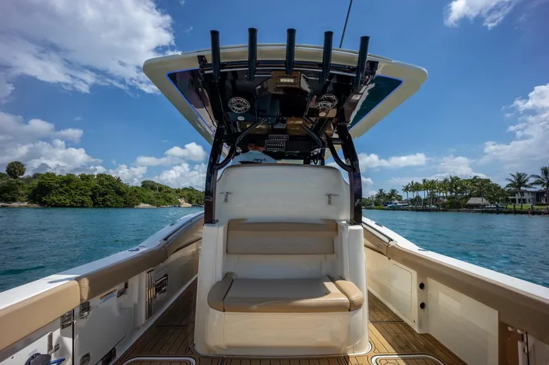 Slide: The Image of 2022 Scout 330 LXF boat interior with seating, ocean view, and blue sky. - 18