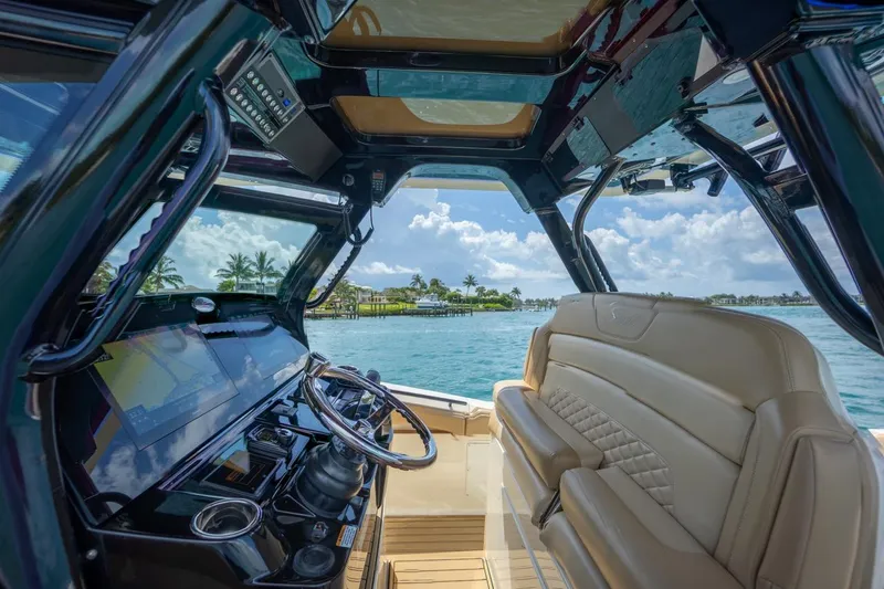 Slide: The Image of Interior view of 2022 Scout 330 LXF boat with luxurious seating and advanced navigation system. - 5