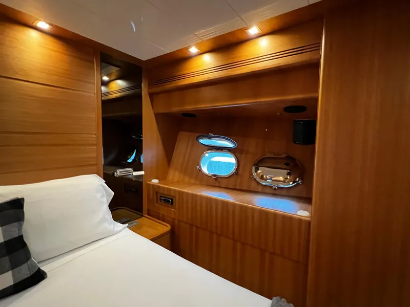 Slide: The Image of Sanlorenzo SL72 2006 yacht cabin with wooden interior and porthole windows. - 12