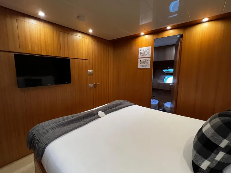 Slide: The Image of Luxurious bedroom on 2006 Sanlorenzo SL72 yacht with wood paneling and ensuite bathroom. - 13