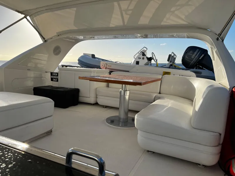 Slide: The Image of Luxurious interior of 2006 Sanlorenzo SL72 yacht with white seating and wooden table. - 18