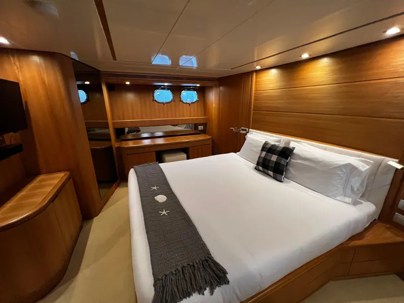Slide: The Image of Luxurious bedroom in a 2006 Sanlorenzo SL72 yacht with modern wooden interior. - 4