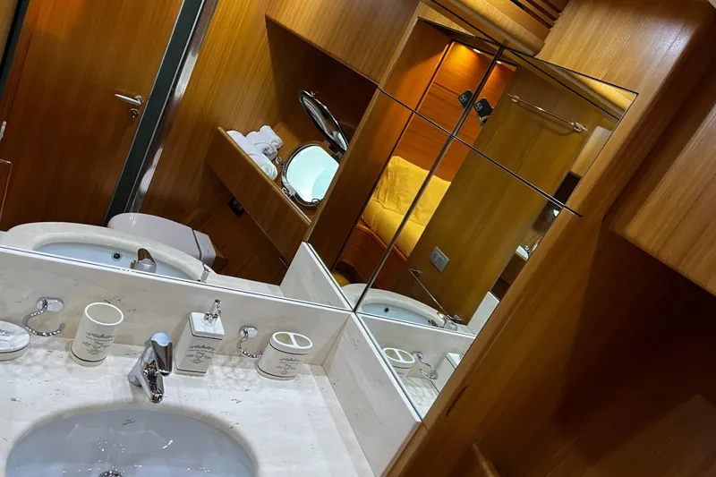 Slide: The Image of Sanlorenzo SL72 2006 yacht bathroom with wooden cabinetry and marble sink. - 7