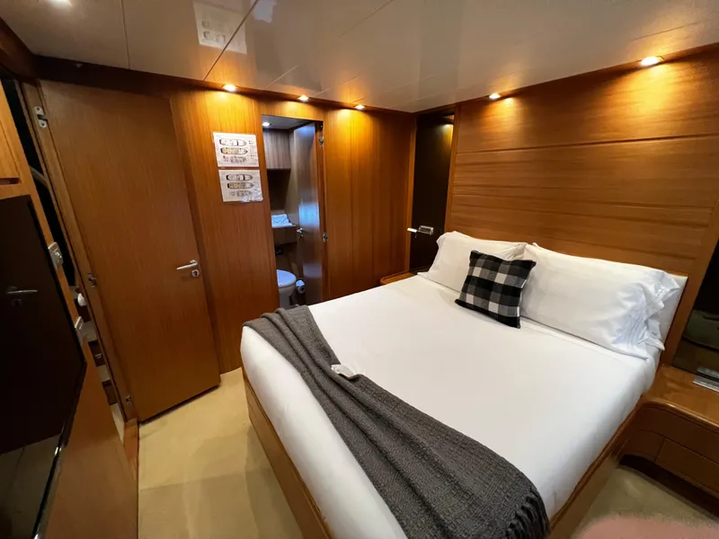 Slide: The Image of Luxurious bedroom on a 2006 Sanlorenzo SL72 yacht with modern wooden interior. - 9