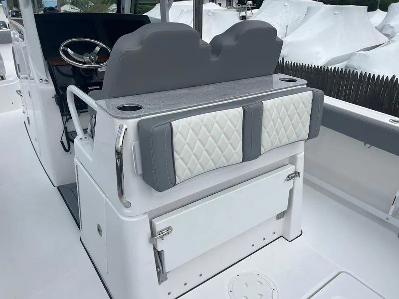 Slide: The Image of 2024 Everglades 285 Center Console boat interior with cushioned seating and storage. - 16