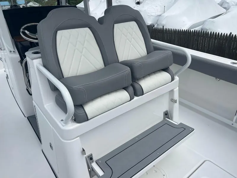 Slide: The Image of 2024 Everglades 285 Center Console boat with dual cushioned seats and footrest. - 17