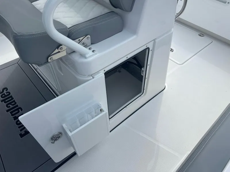 Slide: The Image of 2024 Everglades 285 Center Console boat with open storage compartment and cushioned seating. - 19