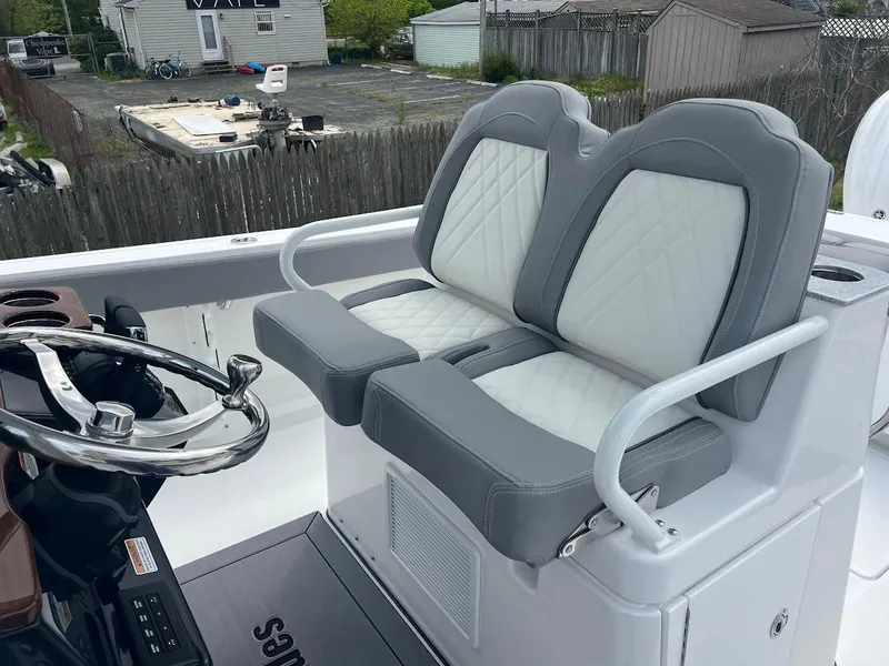 Slide: The Image of 2024 Everglades 285 Center Console boat with dual cushioned seats and steering wheel. - 21