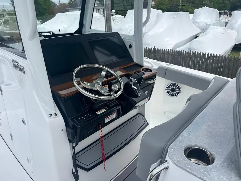 Slide: The Image of 2024 Everglades 285 Center Console boat interior with steering wheel and control panel. - 22