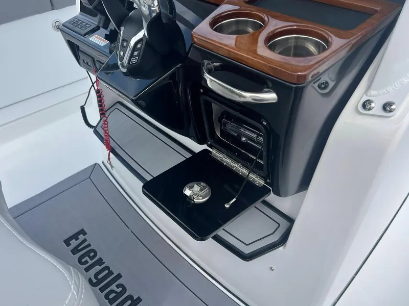 Slide: The Image of 2024 Everglades 285 Center Console boat dashboard with cup holders and storage compartment. - 24