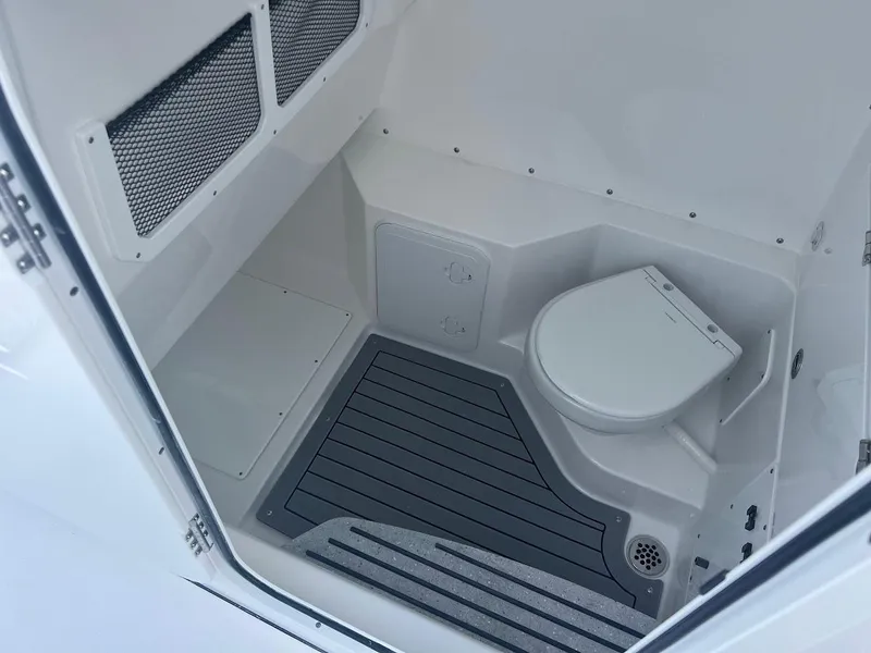 Slide: The Image of 2024 Everglades 285 Center Console boat interior with toilet and storage. - 27
