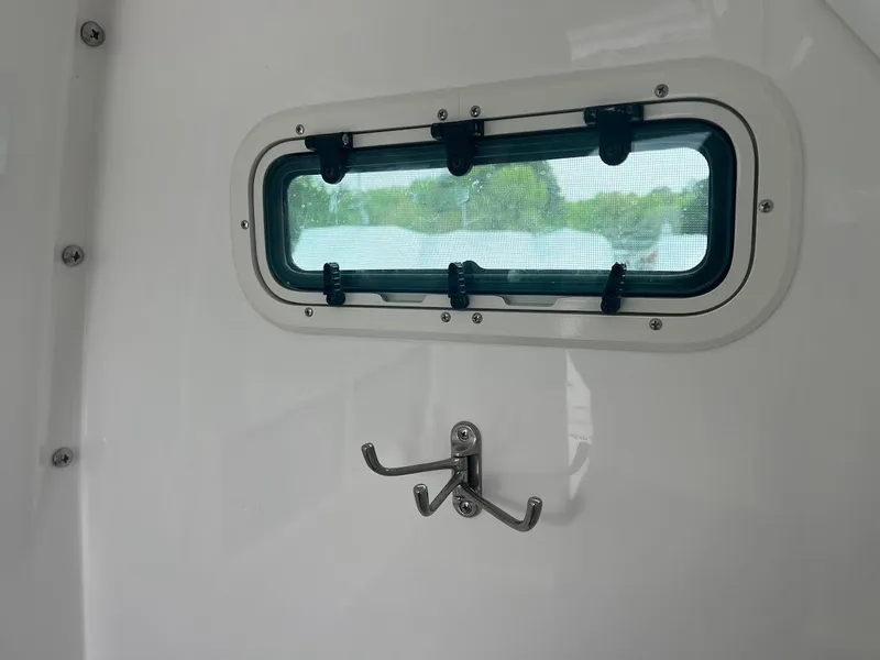 Slide: The Image of 2024 Everglades 285 Center Console interior window and coat hook. - 29