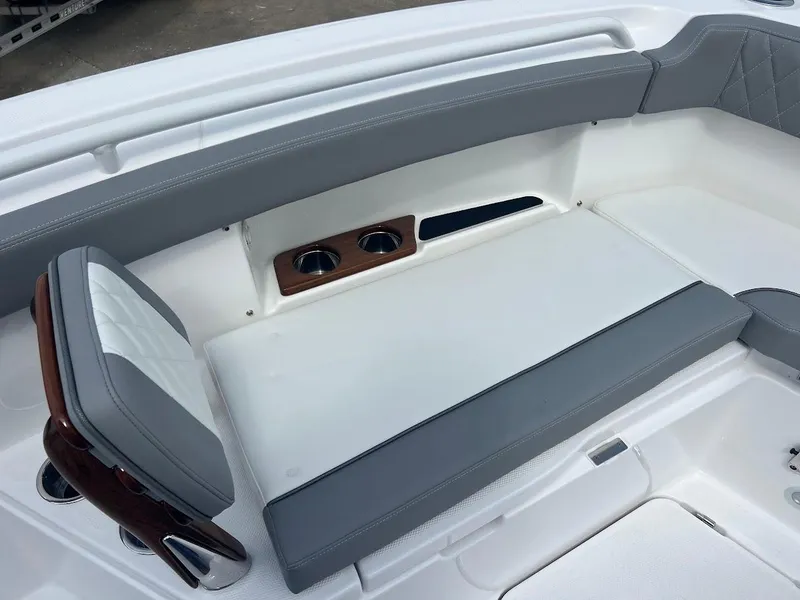 Slide: The Image of 2024 Everglades 285 Center Console boat seating area with cup holders. - 32