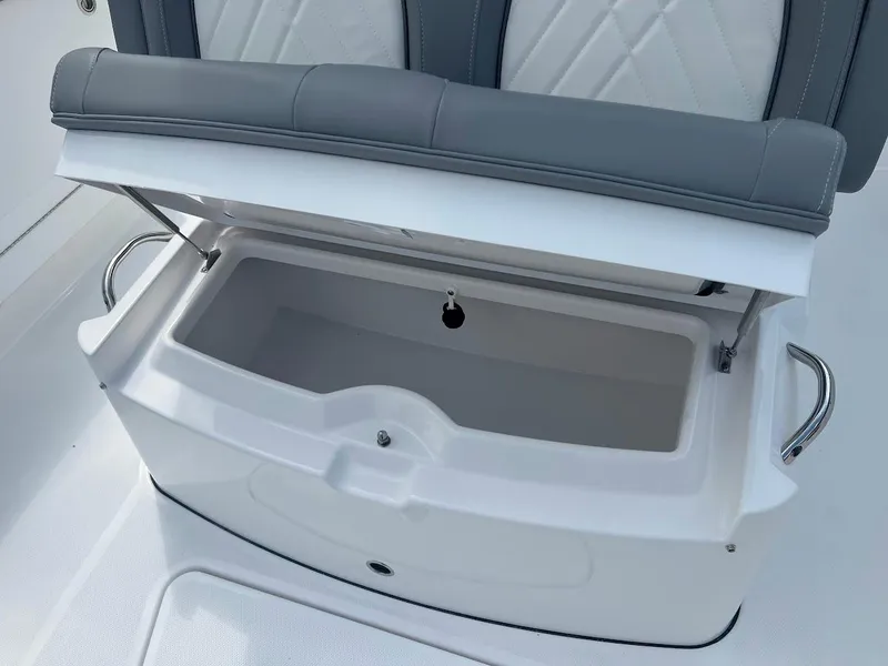Slide: The Image of 2024 Everglades 285 Center Console boat storage compartment with cushioned seat. - 35
