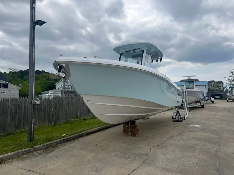 Slide: The Image of 2024 Everglades 285 Center Console boat on display in a marina. - 5