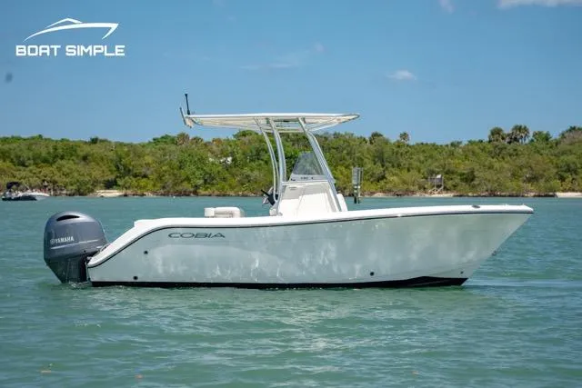 Slide: The Image of 2021 Cobia 201 Center Console boat on water, side view, clear sky. - 0