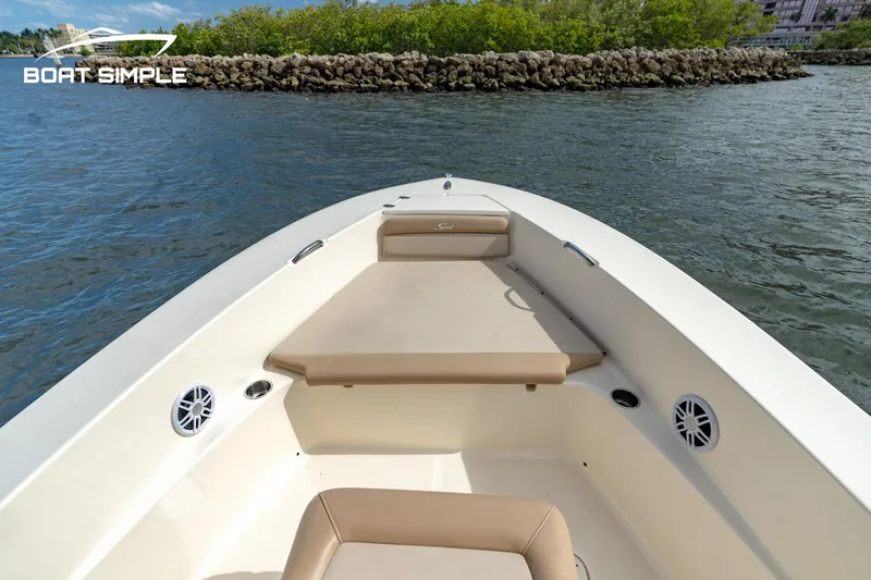 Slide: The Image of 2021 Scout 195 Sportfish boat on water, featuring spacious seating and sleek design. - 5