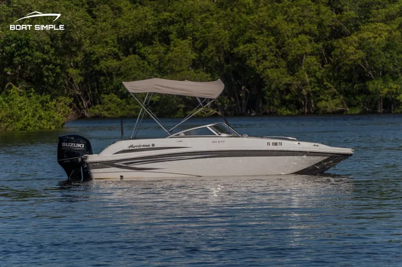 Slide: The Image of 2022 Hurricane 217 SD boat on calm water with Suzuki outboard motor. - 4