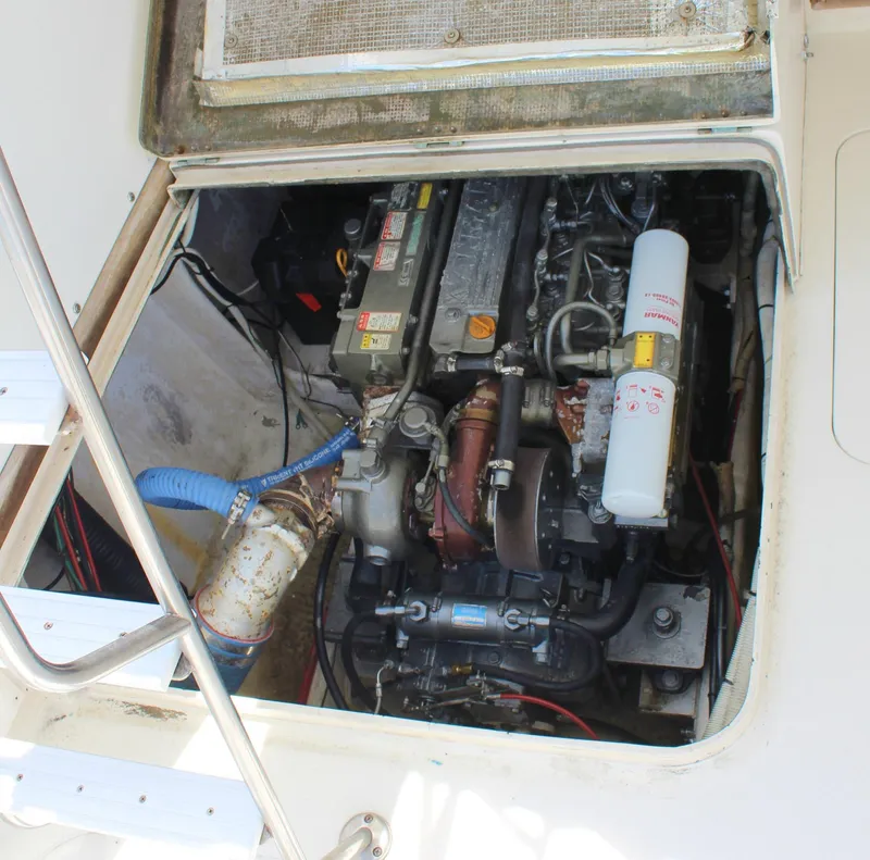Slide: The Image of 1980 Bertram Sport Fisherman engine compartment with visible components and wiring. - 13