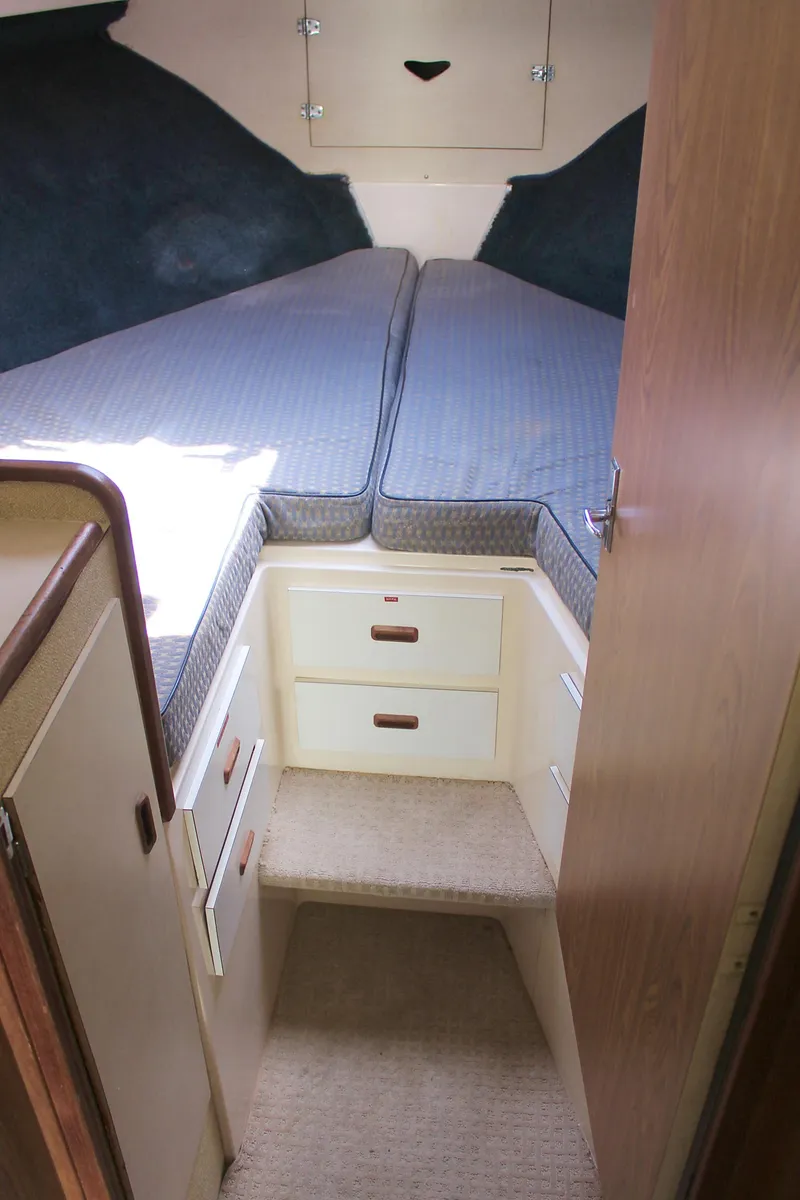 Slide: The Image of 1980 Bertram Sport Fisherman cabin interior with bed and storage drawers. - 22