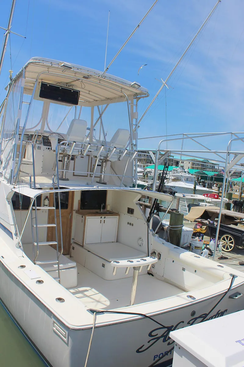 Slide: The Image of 1980 Bertram Sport Fisherman boat docked at a marina. - 3