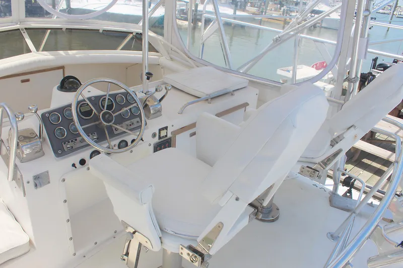 Slide: The Image of 1980 Bertram Sport Fisherman boat cockpit with steering wheel and control panel. - 6