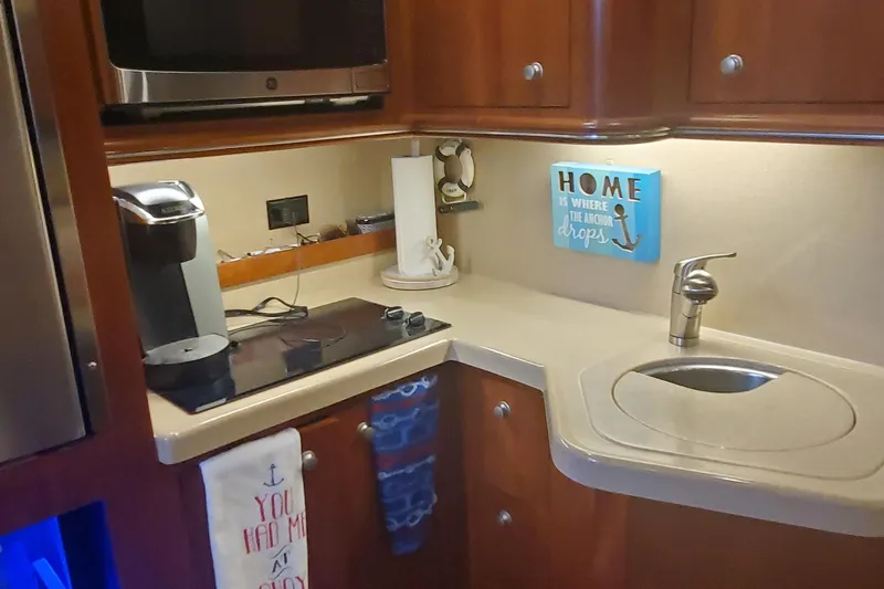 Slide: The Image of 2006 Cruisers Yachts 370 Express kitchen with sink, stove, and coffee maker. - 12