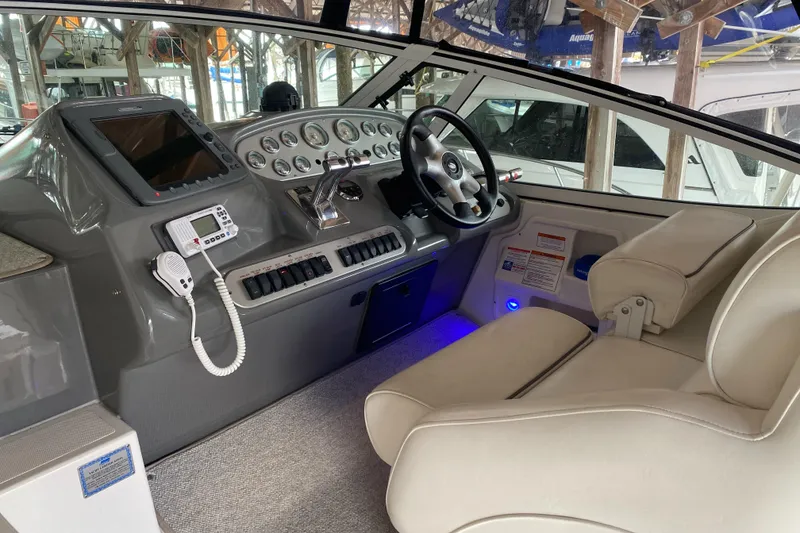 Slide: The Image of 2006 Cruisers Yachts 370 Express helm with modern controls and comfortable seating. - 3