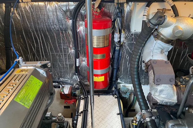 Slide: The Image of Engine room of a 2006 Cruisers Yachts 370 Express with fire extinguisher and mechanical components. - 34