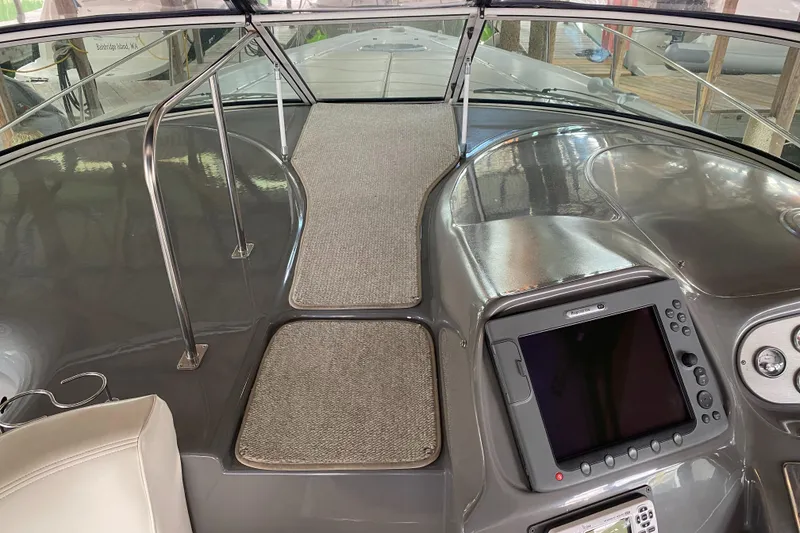 Slide: The Image of 2006 Cruisers Yachts 370 Express helm with navigation system and carpeted walkway. - 5